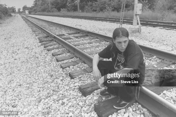 Mike Tester on tracks at point where he & 3 friends jumped CSX train, he becoming separated from 3 & escaping assault & slaying of 1, Michael Carter,...