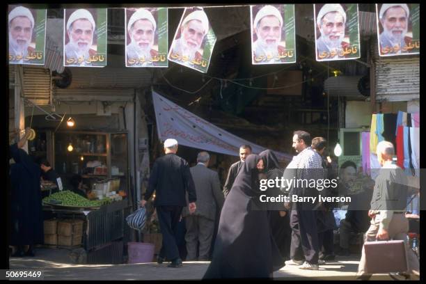 Entrance to bazaar w. Presidential election campaign posters picturing conservative cleric candidate Ali Akbar Nateq-Noori strung overhead & 1...