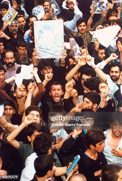 Poster picturing surprise front-runner presidential candidate Mohammed Khatami held high by 1 in crowd of moderate cleric's enthused supporters at...