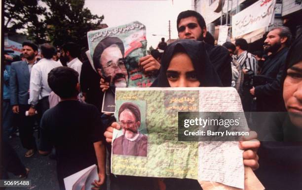 Youthful supporters of surprise front-runner presidential candidate Mohammed Khatami holding moderate cleric's campaign fliers during election...