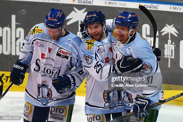 Rene Roethke of Straubing celebrates his team's fifth goal with team mates Alexander Dotzler and Sebastian Osterloh during the DEL match between...