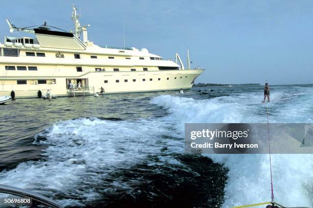 Billionaire investor Saudi Prince Alwaleed water skiing, towed by boat launched from his yacht, Kingdom 5-KR, formerly owned by US real estate mogul...