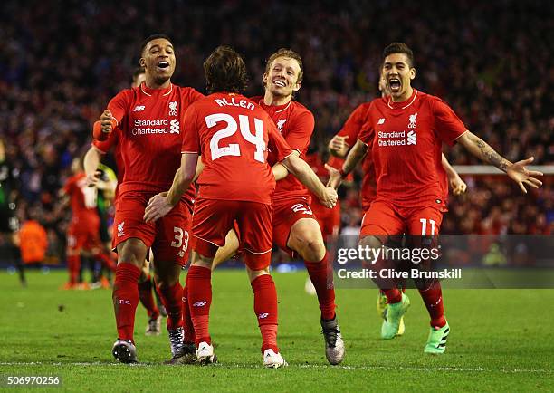 Joe Allen of Liverpool is congratulated by team mates as he scores the decisive penalty in the shoot out during the Capital One Cup semi final second...