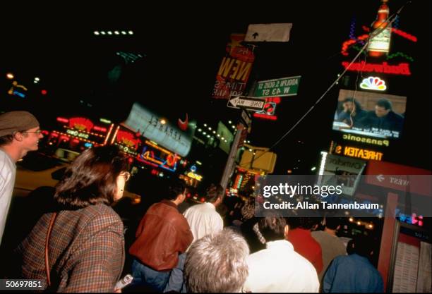 Times Square, New York at night w. Crowds viewing final episode of the TV sitcom Seinfeld on Sony's huge Jumbotron TV.