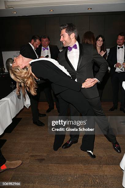 Giulia Siegel and Christian Polanc dances during the Smoking Cocktail at Kaefer Atelier on January 26, 2016 in Munich, Germany.