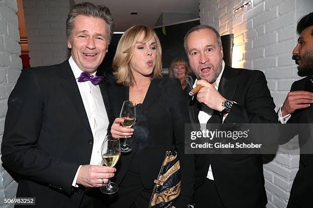 Timothy Peach, Saskia Valencia and Thomas Darchinger smokes during the Smoking Cocktail at Kaefer Atelier on January 26, 2016 in Munich, Germany.