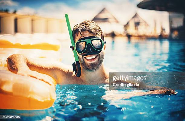 man snorkeling in a swimming pool - scuba mask stock pictures, royalty-free photos & images