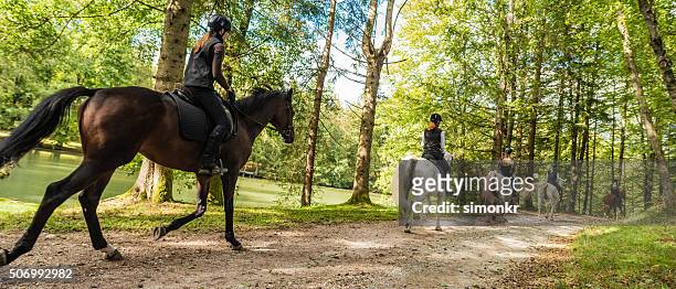 women riding horses - stirrup stock pictures, royalty-free photos & images