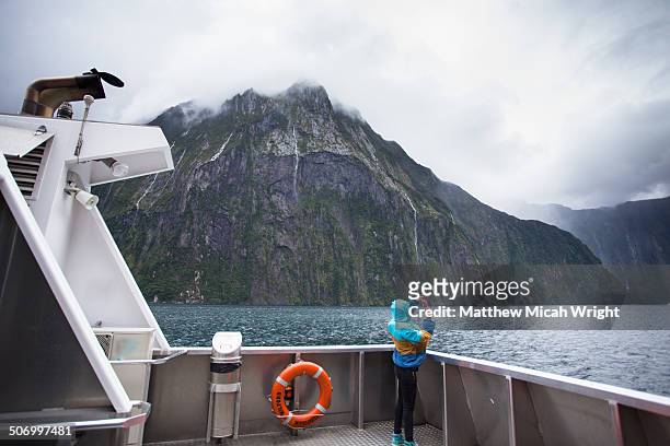 a boat cruise through milford sound. - milford sound stock pictures, royalty-free photos & images