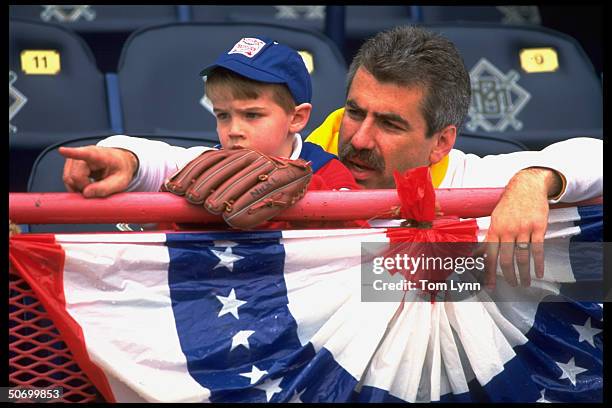 View of child fan in stands holding glove before game of Chicago White Sox vs Milwaukee Brewers.