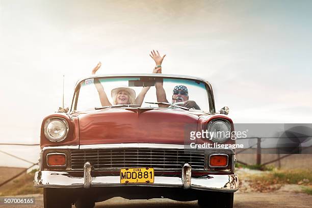 funky mature couple in cuba - car sunset arm stock pictures, royalty-free photos & images