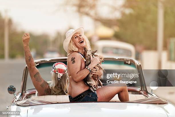 funky mature couple in cuba - car sunset arm stock pictures, royalty-free photos & images