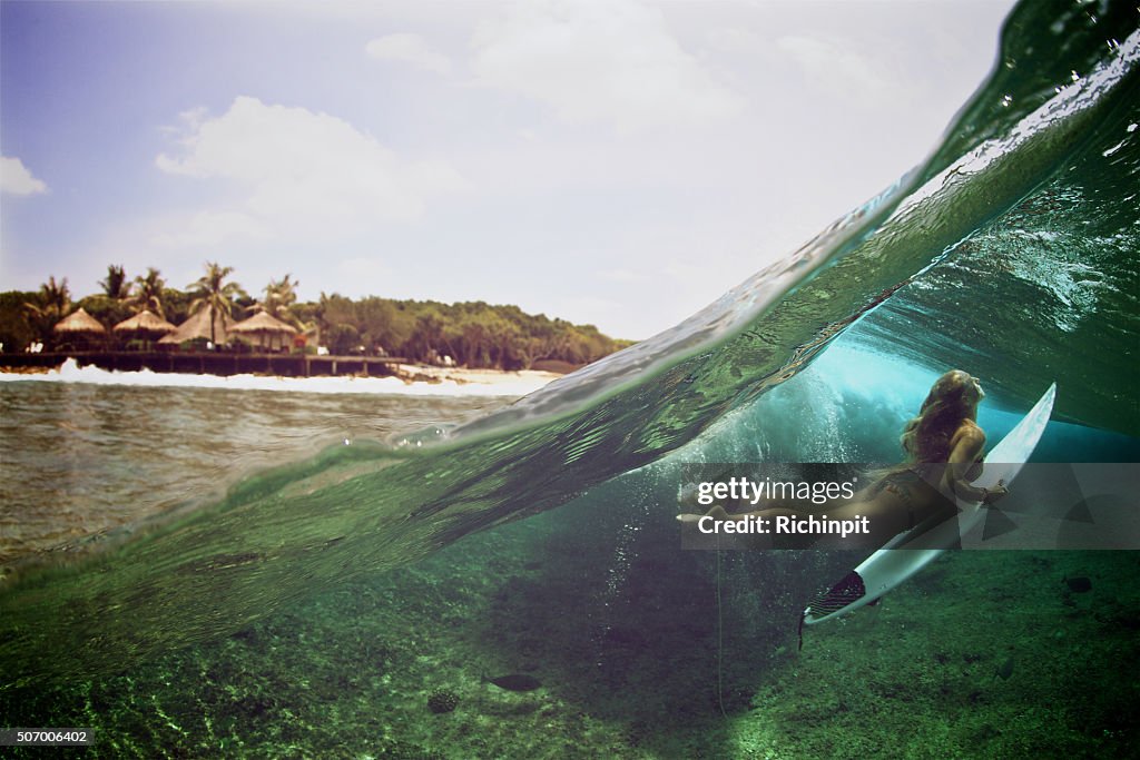 Over under duck dive photo of a surfer girl