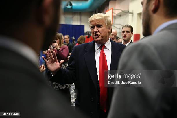 Republican presidential candidate Donald Trump talks with football players from the University of Iowa after they presented him with a football...