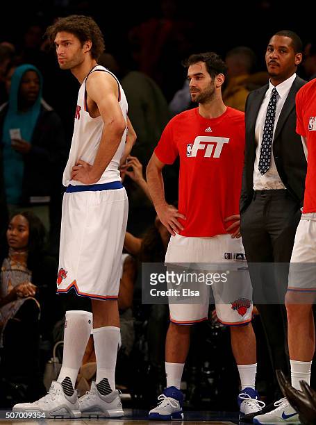 Robin Lopez,Jose Calderon and Carmelo Anthony of the New York Knicks look on from the bench as the Oklahoma City Thunder win in overtime at Madison...