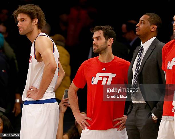 Robin Lopez,Jose Calderon and Carmelo Anthony of the New York Knicks look on from the bench as the Oklahoma City Thunder win in overtime at Madison...