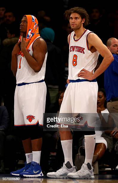 Kevin Seraphin and Robin Lopez of the New York Knicks react to the loss to the Oklahoma City Thunder at Madison Square Garden on January 26, 2016 in...