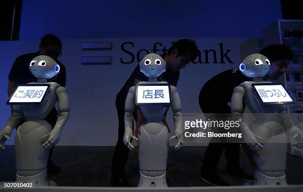 Humanoid robots named Pepper, developed by SoftBank Group Corp., appear on the stage during a news conference prior to the Pepper World 2016 event in...