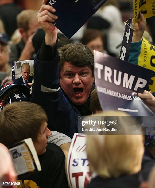 People reach out to greet Republican presidential candidate Donald Trump during a campaign event at the University of Iowa on January 26, 2016 in...