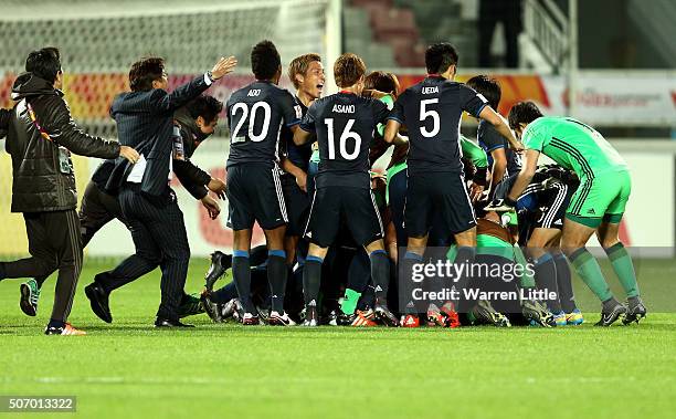 The Japanese players celebrate after winning the AFC U-23 Championship semi final match between Japan and Iraq at the Abdullah Bin Khalifa Stadium on...