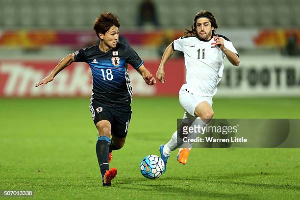 Yosuke Ideguchi of Japan in action during the AFC U-23 Championship semi final match between Japan and Iraq at the Abdullah Bin Khalifa Stadium on...