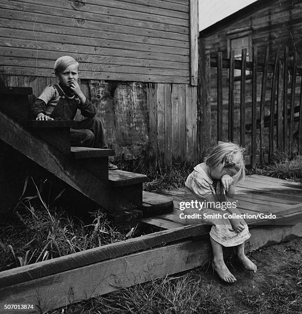 Children on the steps of a dilapidated house, Michigan, 1937. From the New York Public Library. .