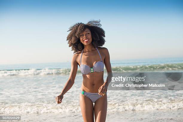 black woman smiles at the beach - swimwear ストックフォトと画像
