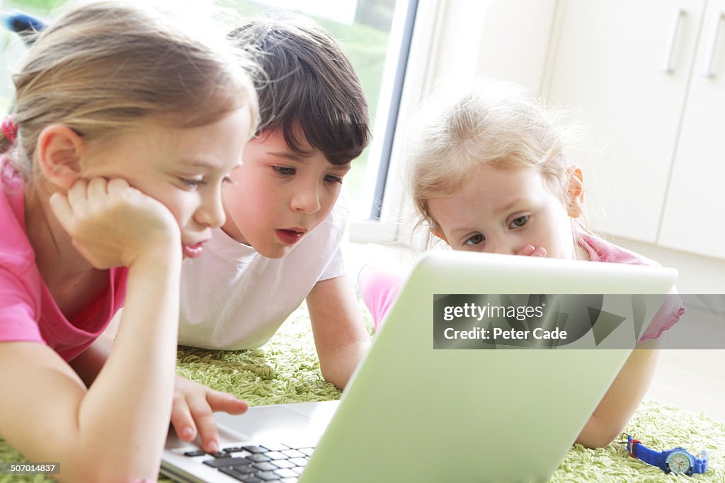 Three childrenn looking at laptop