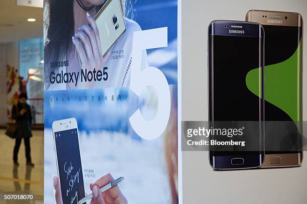 An advertisement for the Samsung Electronics Co. Galaxy Note5 smartphone is displayed at the company's D'light flagship store in Seoul, South Korea,...