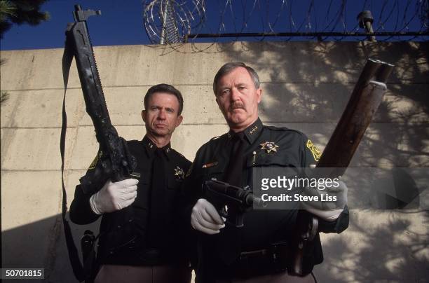 Sheriffs John Dunaway & John Stone) showing 3 weapons used by Columbine High School student gunmen Eric Harris & Dylan Klebold in their April assault...