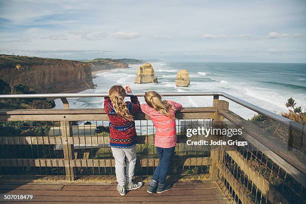 children looking out at rugged coastline - victoria australia 個照片及圖片檔