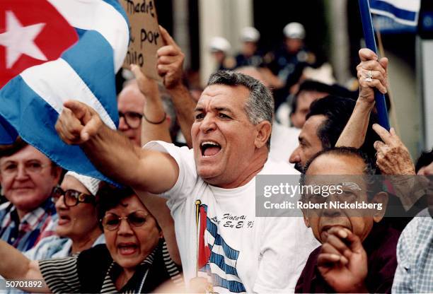 Cuban Americans protesting INS decision to return Elian Gonzalez to Cuba, surviving rafter whose mom drowned when their refugee boat sank, at center...