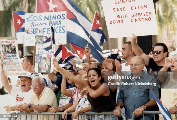 Sign & flag-waving Cuban Americans protesting INS decision to return Elian Gonzalez to Cuba, surviving rafter whose mom drowned when their refugee...