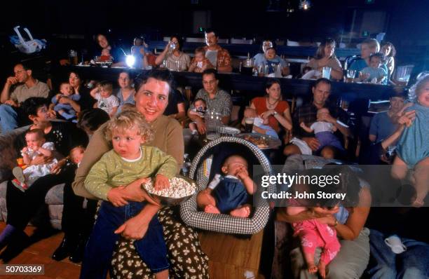 Movie theater co-owner Catherine Fischer , with nieces Charlotte and Suzanna Coffin . Fischer came up with the idea for infant-friendly evenings in...