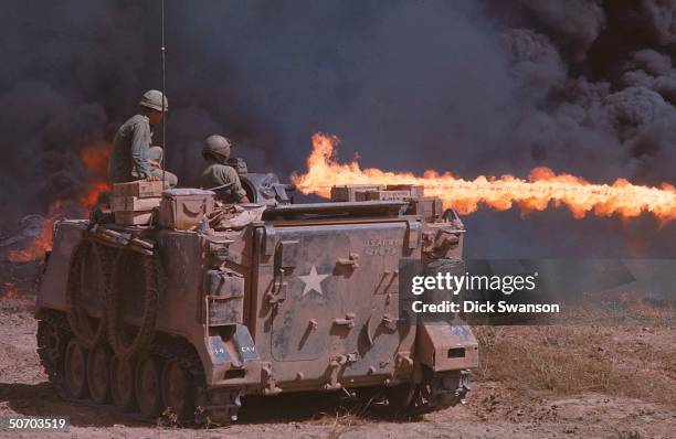 Soldiers of 1st Squadron, 4th Cavalry on Zippo Tracks armored personnel carriers incinerating Iron Triangle area during Operation Cedar Falls.