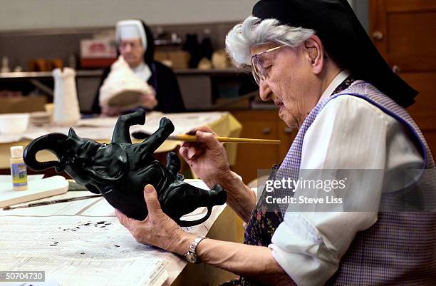 Sister Esther working on a ceramic crafts project, among the 678 subjects of the long-term Nun Study of Alzheimer's disease which University of...