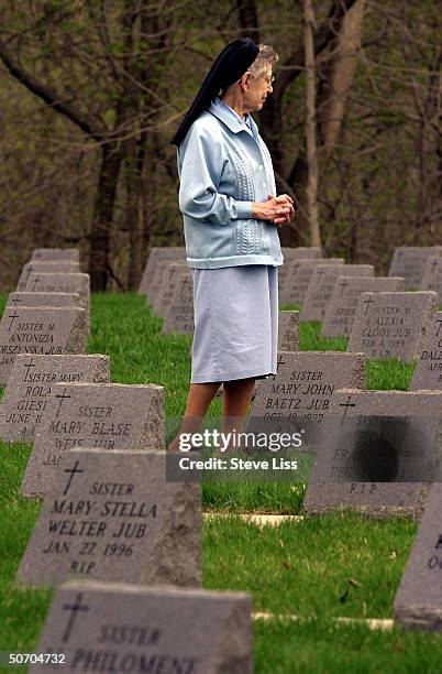 Sister Solana walking in convent cemetery, among the 678 subjects of the long-term Nun Study of Alzheimer's disease which University of Kentucky...