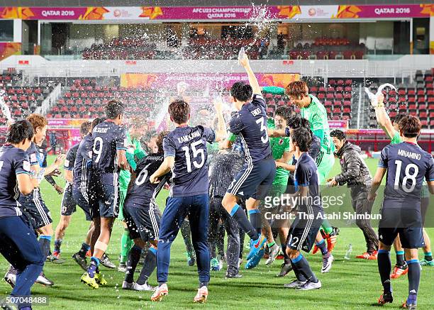 Japanese players celebrate qualifying for the Rio de Janeiro Olympics after their 2-1 win in the AFC U-23 Championship semi final match between Japan...