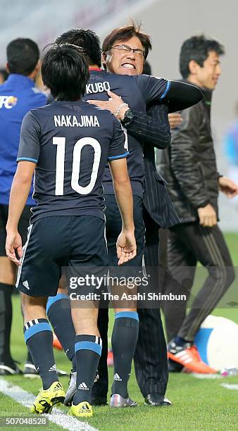 Yuya Kubo of Japan celebrates scoring his team's first goal with head coach Makoto Teguramori during the AFC U-23 Championship semi final match...