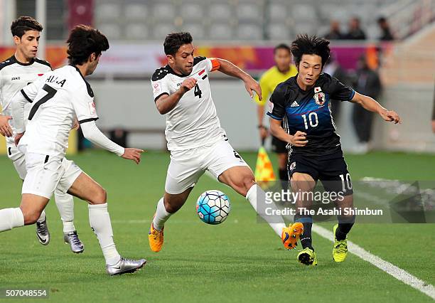 Shoya Nakajima of Japan and Mustafa Nadhim Al-Shabbani of Iraq compete for the ball during the AFC U-23 Championship semi final match between Japan...