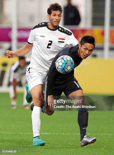 Yuya Kubo of Japan and Suad Natiq Naji of Iraq compete for the ball during the AFC U-23 Championship semi final match between Japan and Iraq at the...