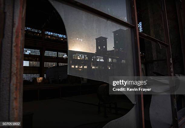 The broken window of a building in the abandoned Qingquan Steel plant which closed in 2014 and became one of several so-called "zombie factories", on...