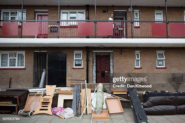 Man walks past discarded furniture outside a social housing estate in Tower Hamlets on August 10, 2015 in London, England.