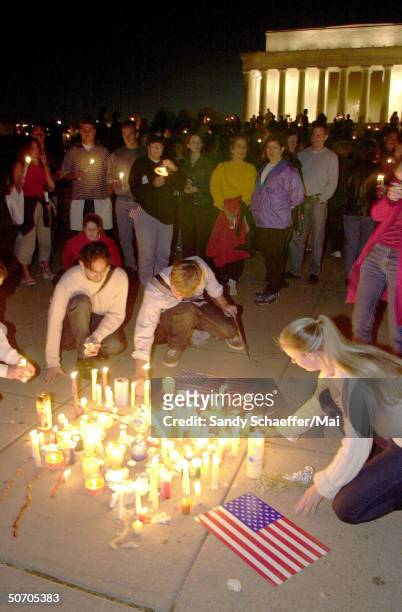 Mourners burning candles during vigil at Lincoln memorial. Across the nation, at 7PM, candles burned for those who died or were injured in the...