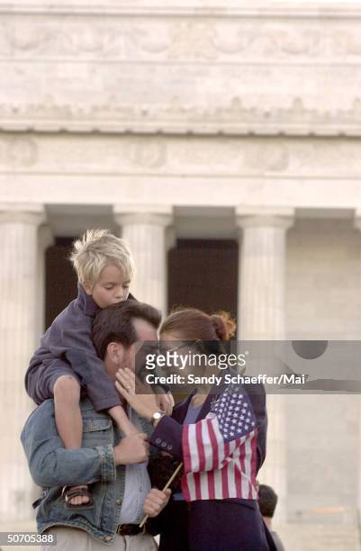 Mark Notturno & his wife Kira Viktorova & their son Karl comforting each other during a vigil on the steps of the Lincolm Memorial honoring those who...
