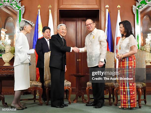 Emperor Akihito and Filipino President Benigno Aquino shake hands while Empress Michiko and Aurora Corazon Aquino-Abellada watch during their meeting...