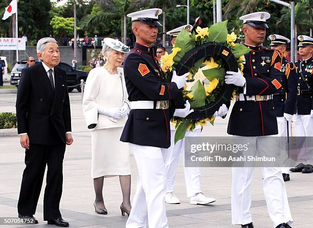 Emperor Akihito and Empress Michiko offer a wreath of flowers at the monument of Philippine national hero Jose Rizal on January 27, 2016 in Manila,...