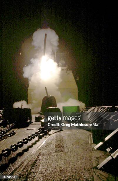Tomahawk cruise missile launching from the USS Philippine Sea in a strike against al Qaeda terrorist training camps and military installations of the...