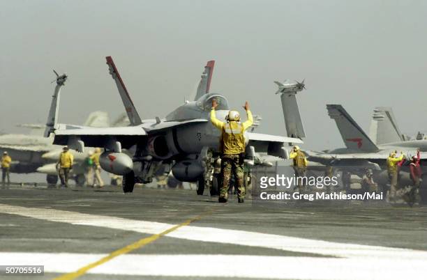 An F/A-18C Hornet preparing for launch from the aircraft carrier USS Carl Vinson in a strike against al Qaeda terrorist training camps and military...