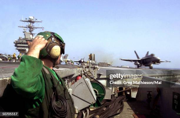 An F/A-18C Hornet launching from the aircraft carrier USS Carl Vinson in a strike against al Qaeda terrorist training camps and military...